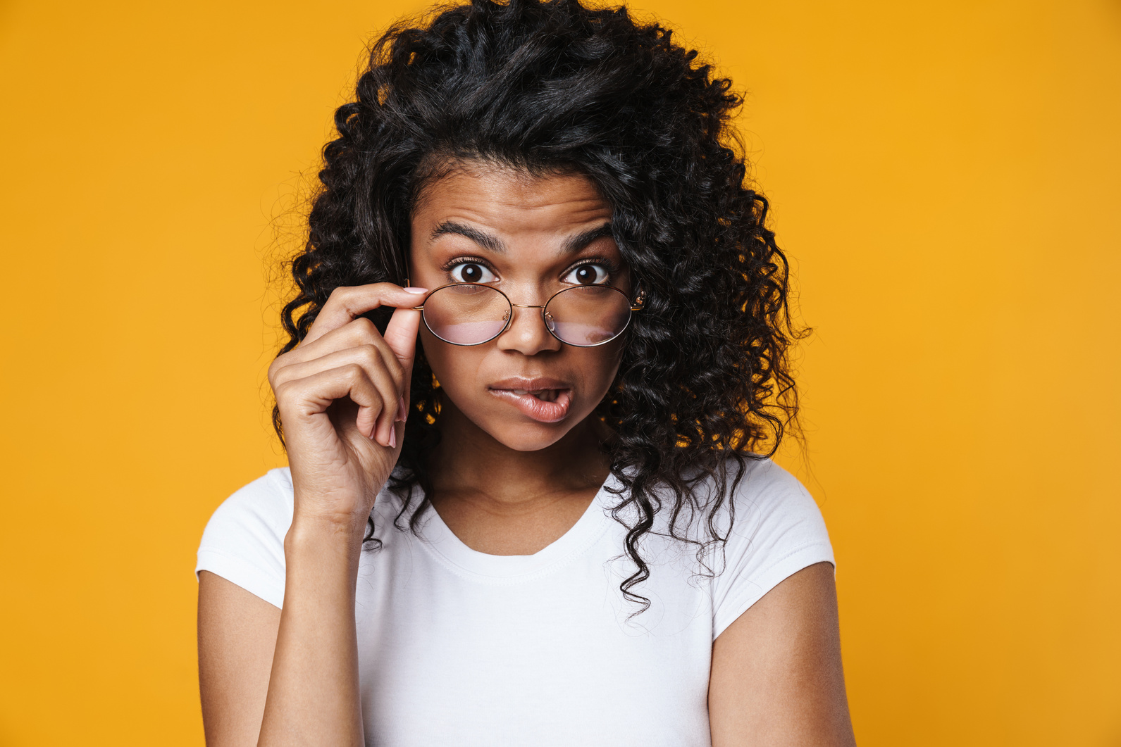 Image of Confused African American Woman in Eyeglasses Looking at Camera